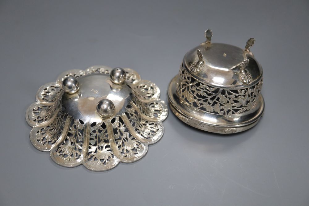 A Chinese pierced white metal flowerhead bowl, diameter 12.2cm, maker MT and a similar small swing-handled basket (2)